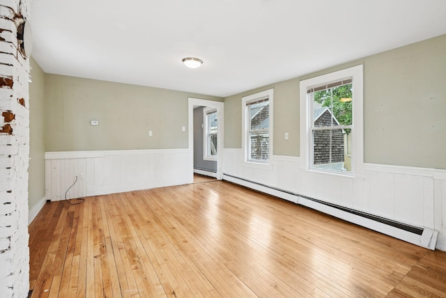 82 Winter St, Portland, ME 04102 - spare room with a wainscoted wall, a baseboard heating unit, wood-type flooring, and baseboard heating
