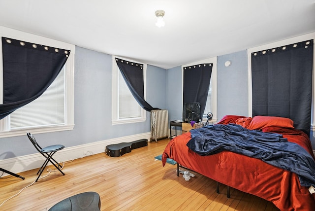 82 Winter St, Portland, ME 04102 - bedroom featuring radiator, wood finished floors, and baseboards