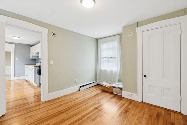 82 Winter St, Portland, ME 04102 - empty room featuring light wood-type flooring, a baseboard radiator, and baseboards