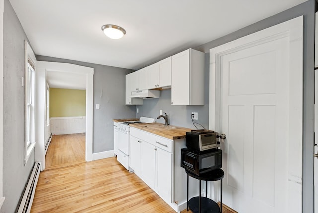 82 Winter St, Portland, ME 04102 - kitchen featuring a baseboard radiator, light wood-type flooring, under cabinet range hood, wood counters, and white gas range oven