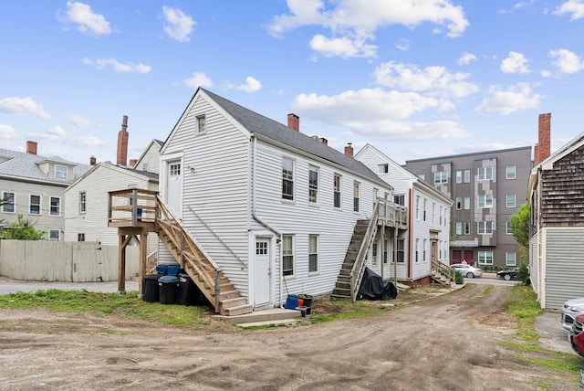 82 Winter St, Portland, ME 04102 - rear view of property featuring stairs, a deck, a chimney, and a residential view