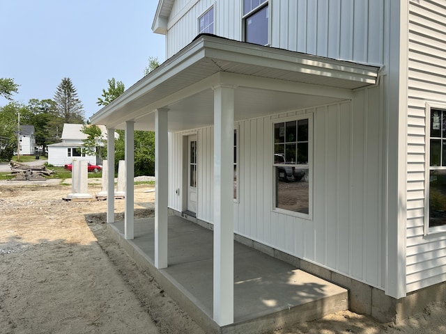 11 Spring St, Lisbon, ME 04250 - view of exterior entry featuring a porch and board and batten siding