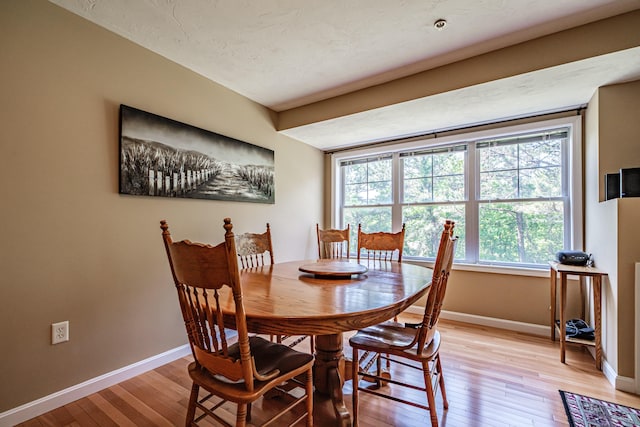 170 E Grand Ave Unit 1, Old Orchard Beach, ME 04064 - dining room featuring baseboards and light wood-style flooring
