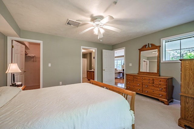 170 E Grand Ave Unit 1, Old Orchard Beach, ME 04064 - carpeted bedroom with a walk in closet, ensuite bathroom, ceiling fan, and baseboards
