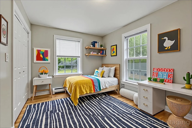 8 Rileys Run, Berwick, ME 03901 - bedroom with baseboard heating, light wood-type flooring, a closet, and baseboards
