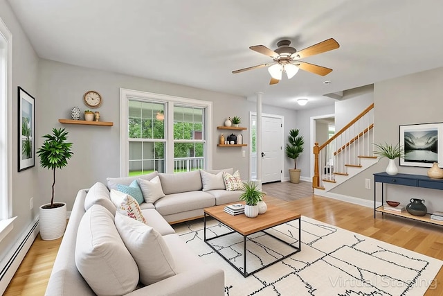 8 Rileys Run, Berwick, ME 03901 - living area featuring a baseboard radiator, stairs, light wood finished floors, ceiling fan, and baseboards