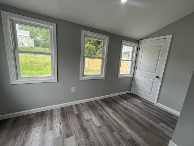 6 Hidden Ave, Livermore Falls, ME 04254 - empty room with vaulted ceiling, healthy amount of natural light, dark wood-type flooring, and baseboards