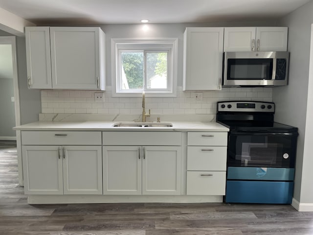 6 Hidden Ave, Livermore Falls, ME 04254 - kitchen featuring stainless steel microwave, electric range oven, a sink, decorative backsplash, and recessed lighting