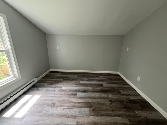 6 Hidden Ave, Livermore Falls, ME 04254 - bonus room with baseboard heating, vaulted ceiling, dark wood-type flooring, and baseboards