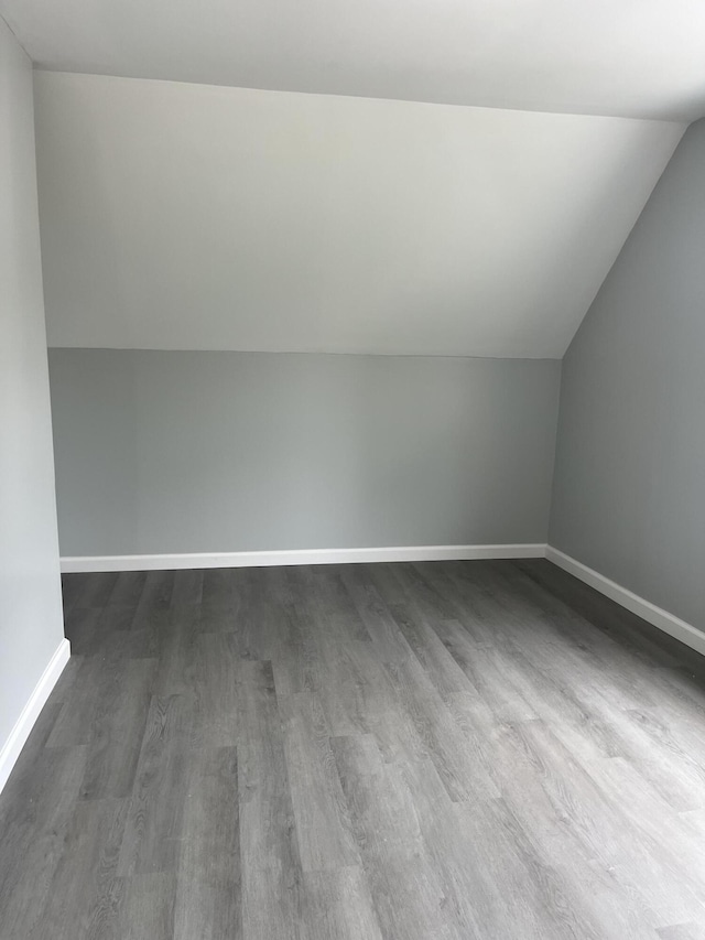 6 Hidden Ave, Livermore Falls, ME 04254 - additional living space with dark wood-style flooring, lofted ceiling, and baseboards