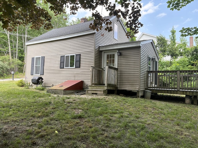 152 Bradman St, Auburn, ME 04210 - back of property featuring a wooden deck, a yard, and a chimney