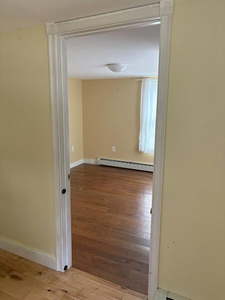 152 Bradman St, Auburn, ME 04210 - corridor featuring a baseboard radiator and wood finished floors