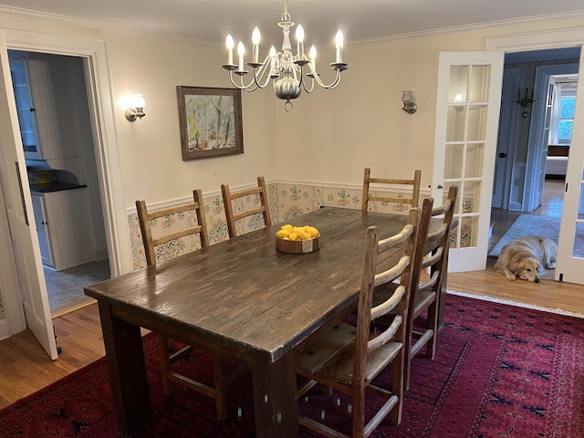 2 Lookout Point Rd, Bar Harbor, ME 04609 - dining area featuring wood finished floors, a chandelier, and crown molding