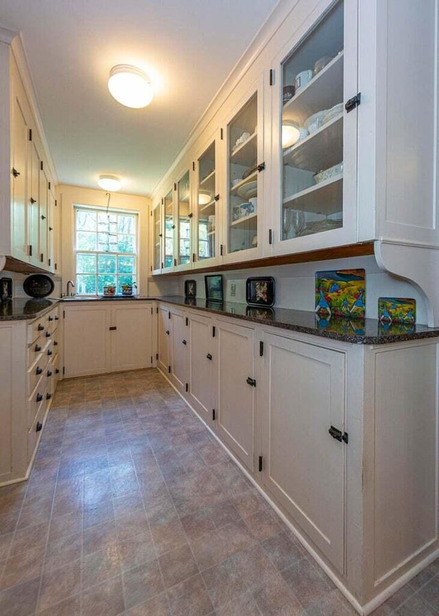 2 Lookout Point Rd, Bar Harbor, ME 04609 - kitchen featuring glass insert cabinets, white cabinetry, and dark stone countertops