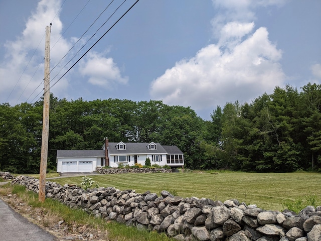 630 Youngs Ridge Rd, Acton, ME 04001 - cape cod-style house with a front lawn, a garage, driveway, and a wooded view