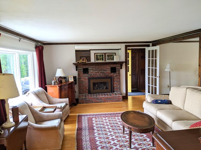 630 Youngs Ridge Rd, Acton, ME 04001 - living area with light wood-type flooring, a fireplace, and crown molding