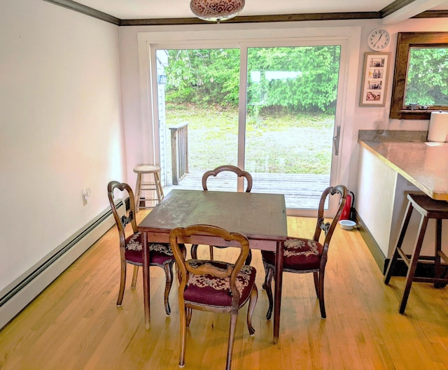 630 Youngs Ridge Rd, Acton, ME 04001 - dining room with baseboard heating, light wood-style floors, crown molding, and baseboards