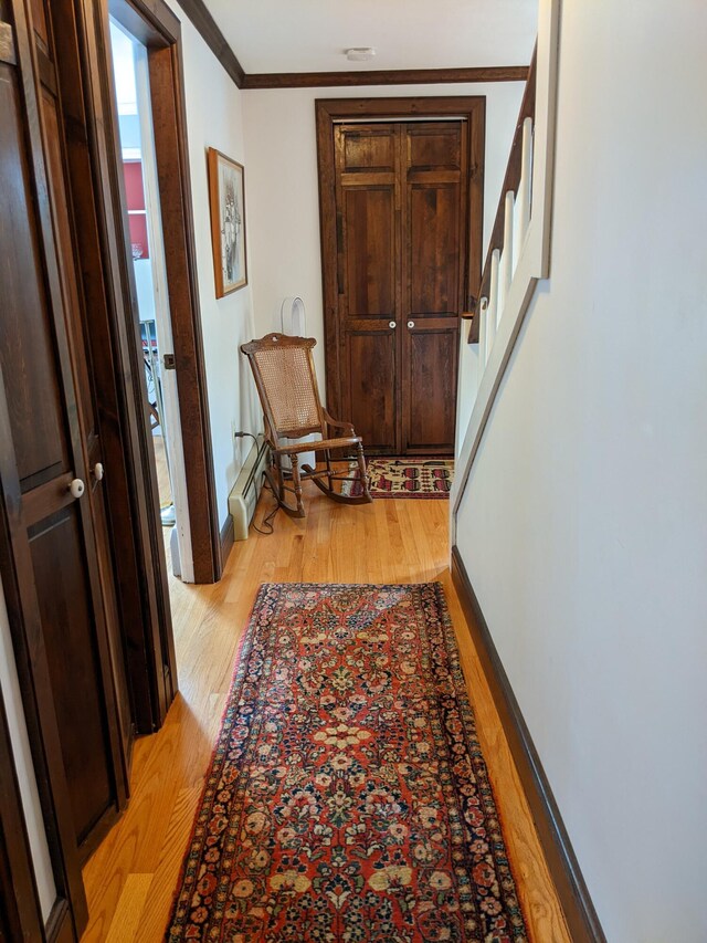 630 Youngs Ridge Rd, Acton, ME 04001 - corridor with light wood-style floors, crown molding, stairs, a baseboard heating unit, and baseboards