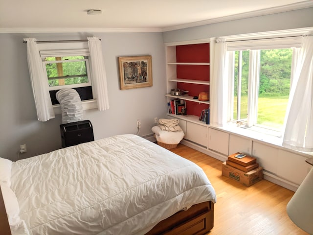 630 Youngs Ridge Rd, Acton, ME 04001 - bedroom with multiple windows, light wood-style flooring, and crown molding