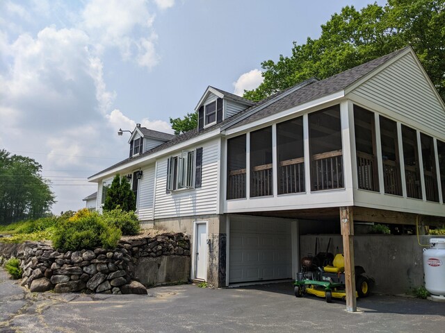 630 Youngs Ridge Rd, Acton, ME 04001 - rear view of property with a sunroom, a garage, driveway, and roof with shingles
