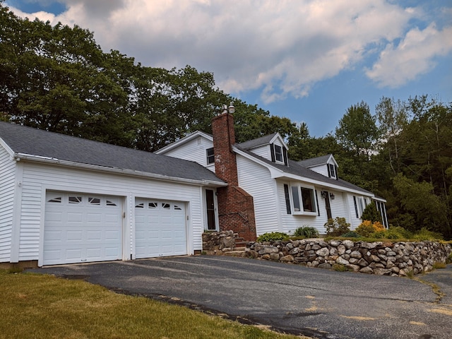 630 Youngs Ridge Rd, Acton, ME 04001 - view of front facade with driveway, an attached garage, and a chimney