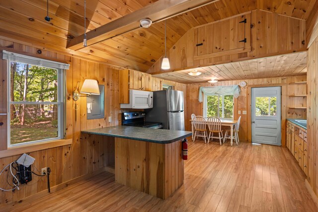 16 Maple Ridge Dr, Monmouth, ME 04259 - kitchen with white microwave, electric range oven, freestanding refrigerator, wooden walls, and dark countertops