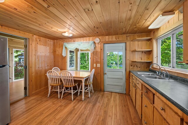 16 Maple Ridge Dr, Monmouth, ME 04259 - dining room with wood ceiling, light wood finished floors, wooden walls, and plenty of natural light