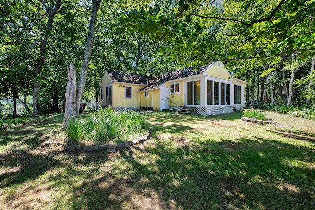 16 Maple Ridge Dr, Monmouth, ME 04259 - back of property with entry steps and a yard