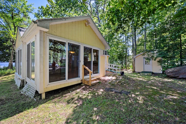 16 Maple Ridge Dr, Monmouth, ME 04259 - back of house featuring an outdoor structure and a sunroom