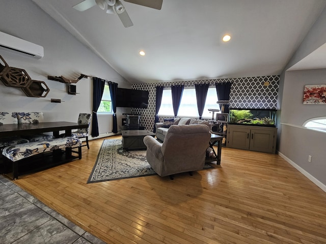30 Cedar Breeze S, Glenburn, ME 04401 - living room featuring lofted ceiling, ceiling fan, a wall unit AC, light wood-style flooring, and plenty of natural light