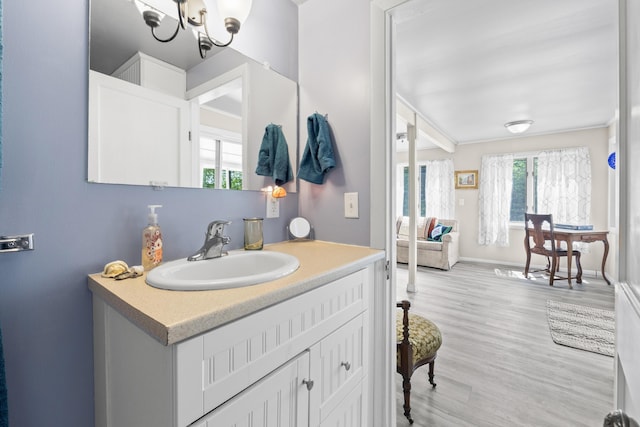 48 E Shore Dr, Greene, ME 04236 - bathroom with a chandelier, vanity, wood finished floors, and baseboards