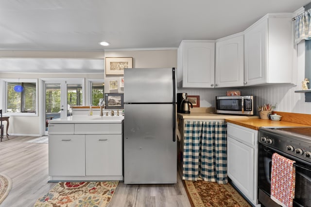 48 E Shore Dr, Greene, ME 04236 - kitchen featuring stainless steel appliances, white cabinetry, light wood finished floors, and recessed lighting
