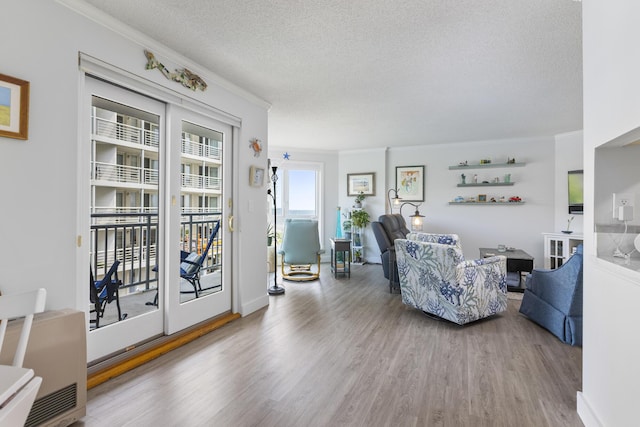 219 E Grand Ave Unit 3C, Old Orchard Beach, ME 04064 - living area featuring wood finished floors, ornamental molding, and a textured ceiling
