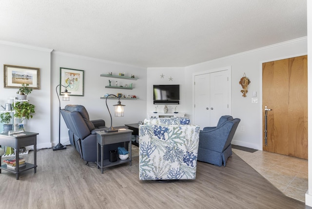 219 E Grand Ave Unit 3C, Old Orchard Beach, ME 04064 - living room featuring ornamental molding, light wood-type flooring, and a textured ceiling
