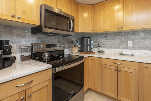 219 E Grand Ave Unit 3C, Old Orchard Beach, ME 04064 - kitchen with appliances with stainless steel finishes, decorative backsplash, and light stone countertops