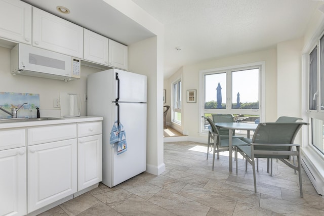 219 E Grand Ave Unit 3C, Old Orchard Beach, ME 04064 - kitchen featuring white appliances, plenty of natural light, and white cabinets