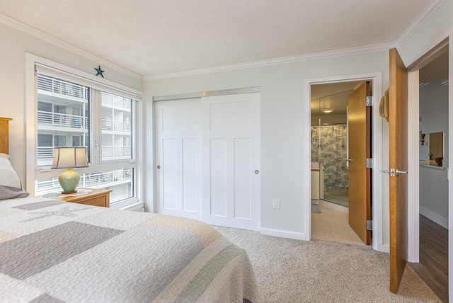219 E Grand Ave Unit 3C, Old Orchard Beach, ME 04064 - bedroom featuring ornamental molding, carpet floors, a closet, and connected bathroom