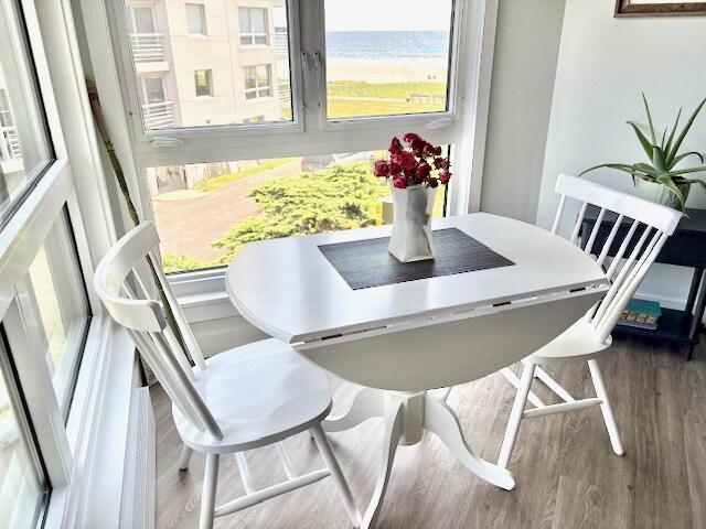 219 E Grand Ave Unit 3C, Old Orchard Beach, ME 04064 - dining space with wood finished floors and a water view
