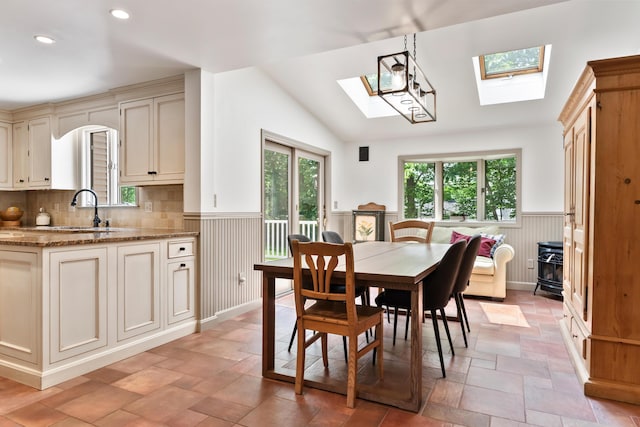 106 Fieldstone Estates Rd, York, ME 03909 - dining space with a skylight, wainscoting, recessed lighting, vaulted ceiling, and light stone finish floors