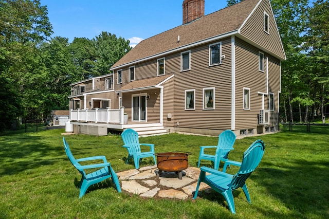 106 Fieldstone Estates Rd, York, ME 03909 - rear view of house with an outdoor fire pit, a chimney, a shingled roof, and a wooden deck