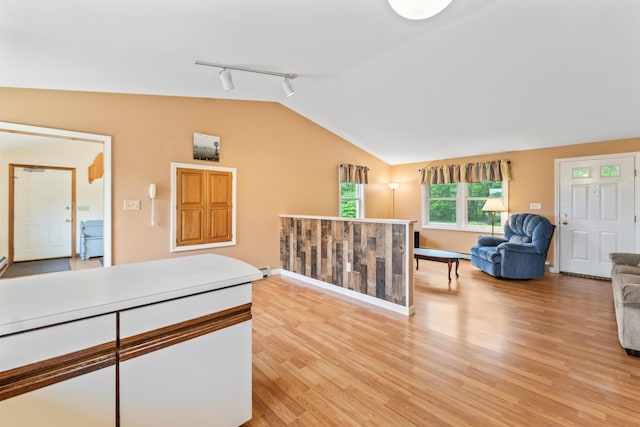 51 Burnham Rd, Saco, ME 04072 - hall with rail lighting, lofted ceiling, light wood finished floors, baseboards, and baseboard heating