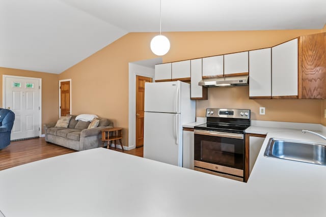 51 Burnham Rd, Saco, ME 04072 - kitchen with stainless steel electric stove, freestanding refrigerator, under cabinet range hood, vaulted ceiling, and a sink