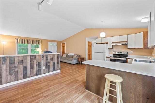 51 Burnham Rd, Saco, ME 04072 - kitchen with electric range, freestanding refrigerator, a sink, lofted ceiling, and under cabinet range hood