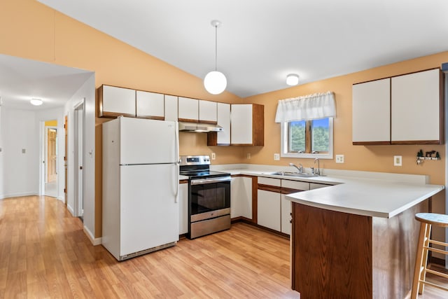 51 Burnham Rd, Saco, ME 04072 - kitchen with stainless steel electric range oven, freestanding refrigerator, a peninsula, a sink, and light wood-type flooring