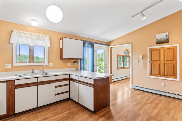 51 Burnham Rd, Saco, ME 04072 - kitchen featuring a sink, a baseboard radiator, vaulted ceiling, a peninsula, and light countertops