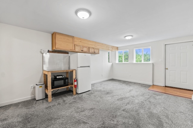 51 Burnham Rd, Saco, ME 04072 - below grade area featuring freestanding refrigerator, baseboards, and carpet