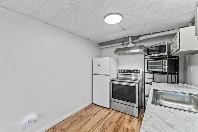 51 Burnham Rd, Saco, ME 04072 - kitchen with appliances with stainless steel finishes, wall chimney exhaust hood, a sink, a paneled ceiling, and light wood-style floors