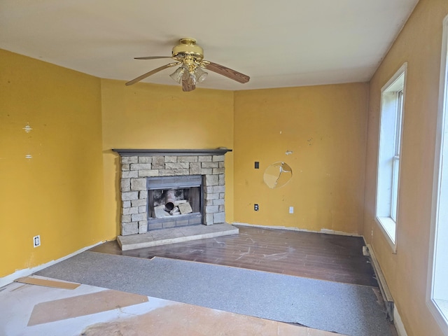 157 Ralph Richardson Rd, Norway, ME 04268 - unfurnished living room with ceiling fan, a fireplace, wood finished floors, and baseboards