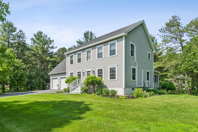 3 Bradfield Way, Kennebunk, ME 04043 - colonial house featuring asphalt driveway, a front yard, a garage, and roof with shingles