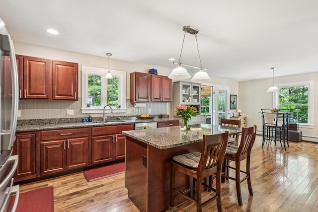3 Bradfield Way, Kennebunk, ME 04043 - kitchen featuring stainless steel appliances, healthy amount of natural light, a breakfast bar, light wood finished floors, and recessed lighting